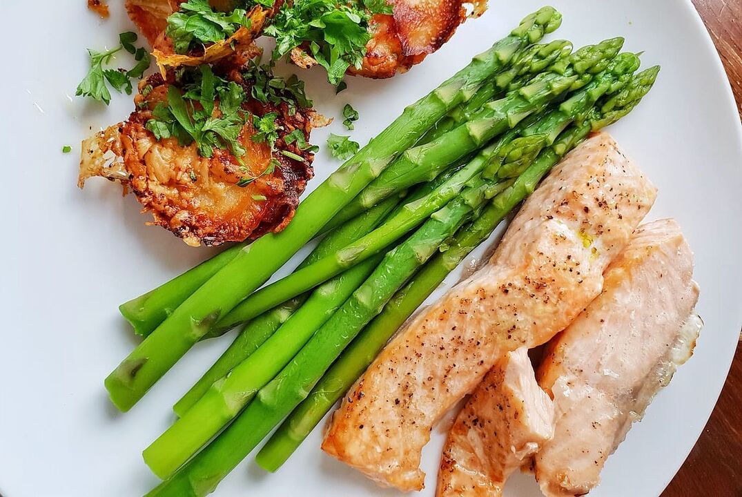 Baked fish with asparagus in low carb diet menu